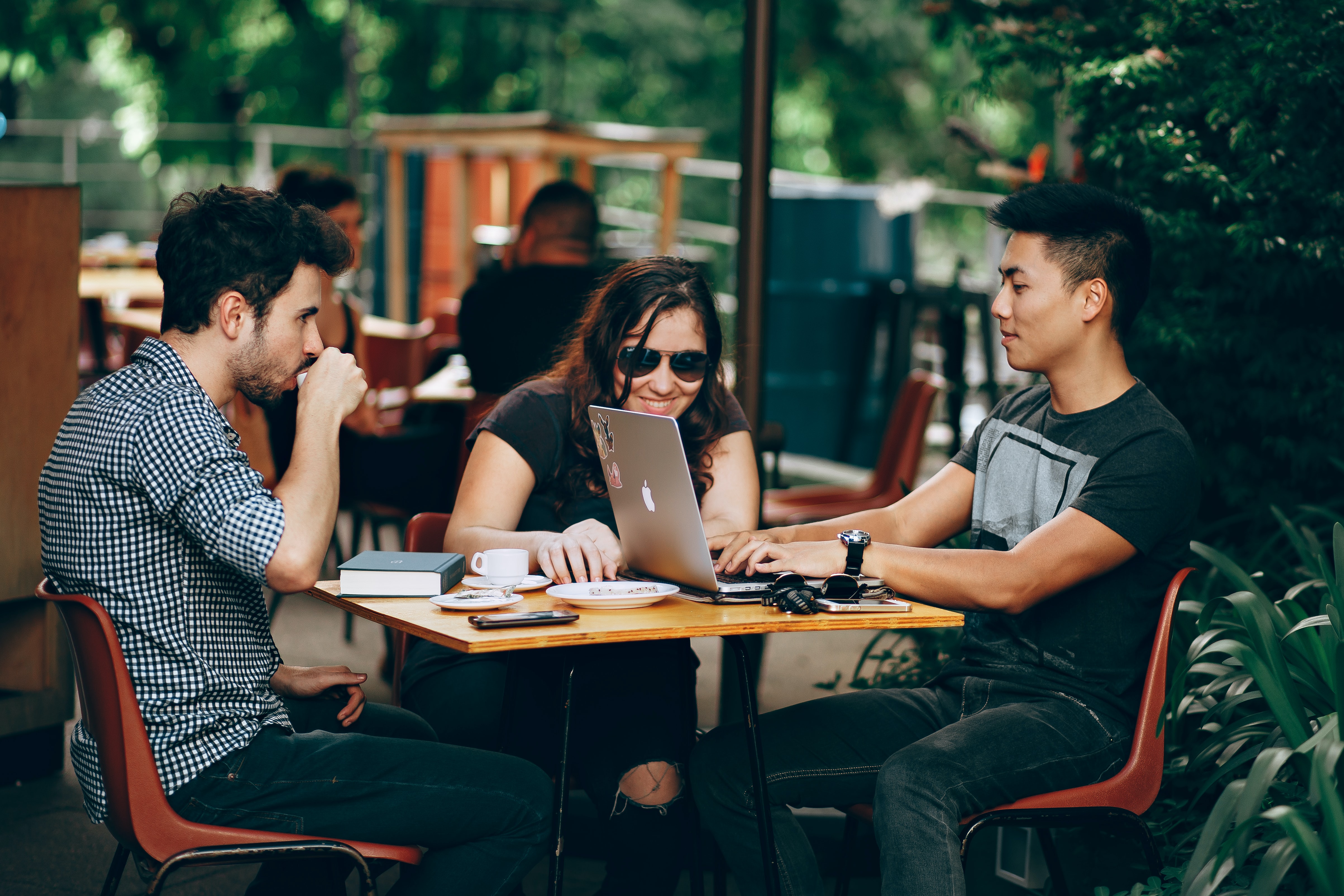 a group of friends enjoying a cup of coffee while chatting.